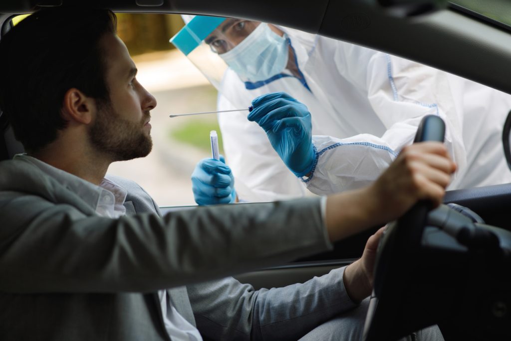 PCR diagnostic, doctor in PPE holding test kit, lockdown, new normal-1024x683